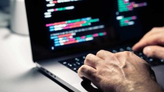 Hacker,With,Malware,Code,In,Computer,Screen.,Cybersecurity,,Privacy,Or