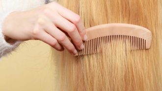 Haircare, choosing best conditioner for tangled hairstyle concept. Blonde woman brushing her hair with comb