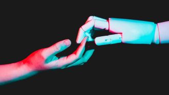 human hand touching robotic hand