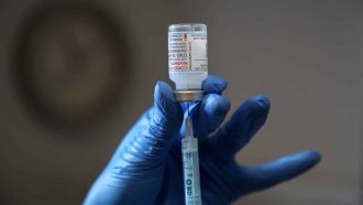 LONDON, UNITED KINGDOM - 2021/08/12: A NHS vaccinator prepares to administer the Moderna Covid-19 vaccine to a member of the public at a vaccination centre in London. (Photo by Dinendra Haria/SOPA Images/LightRocket via Getty Images)