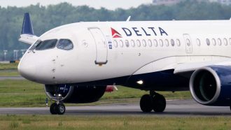 A Delta Air Lines Airbus A220 airplane prepares to takeoff at Ronald Reagan Washington National Airport in Arlington, Virginia, on July 10, 2025. Delta Air Lines stock shares surged more than 11 percent in early trading on Thursday,  as the airline reported better-than-expected results. Between April and June, the group posted year-on-year sales of $16.65 billion and net income of $2.13 billion (+63% year-on-year). (Photo by SAUL LOEB / AFP) (Photo by SAUL LOEB/AFP via Getty Images)
